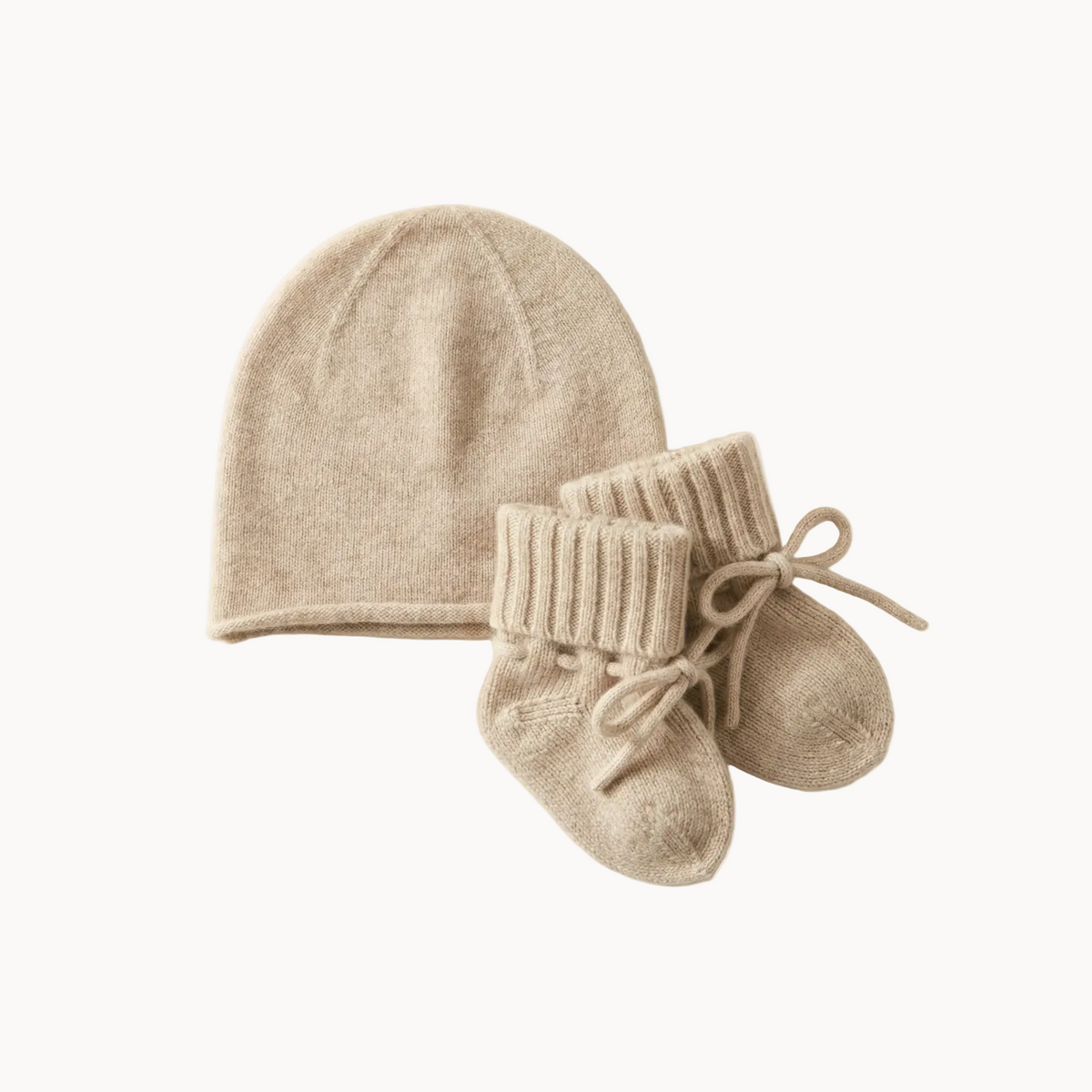 Caramel cashmere baby beanie and coordinating booties, laid flat.