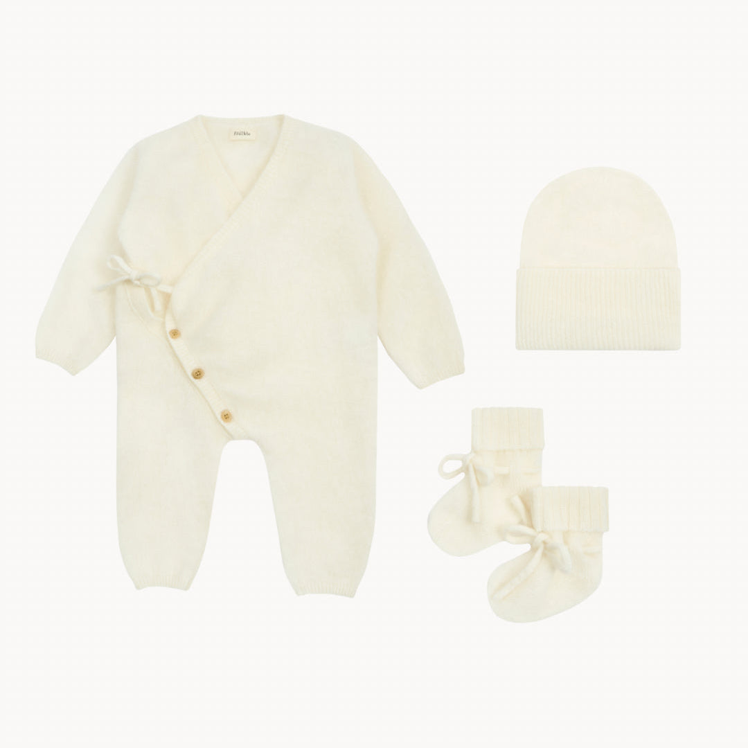 Baby outfit set with onesie, hat, and socks on a white background