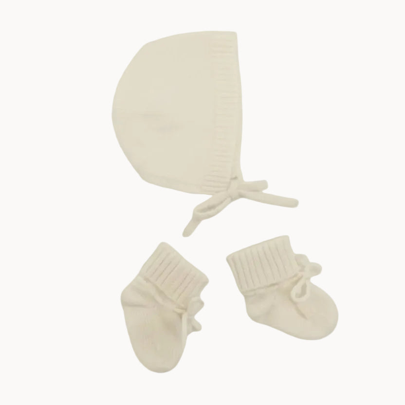 Baby bonnet and booties set on a white background