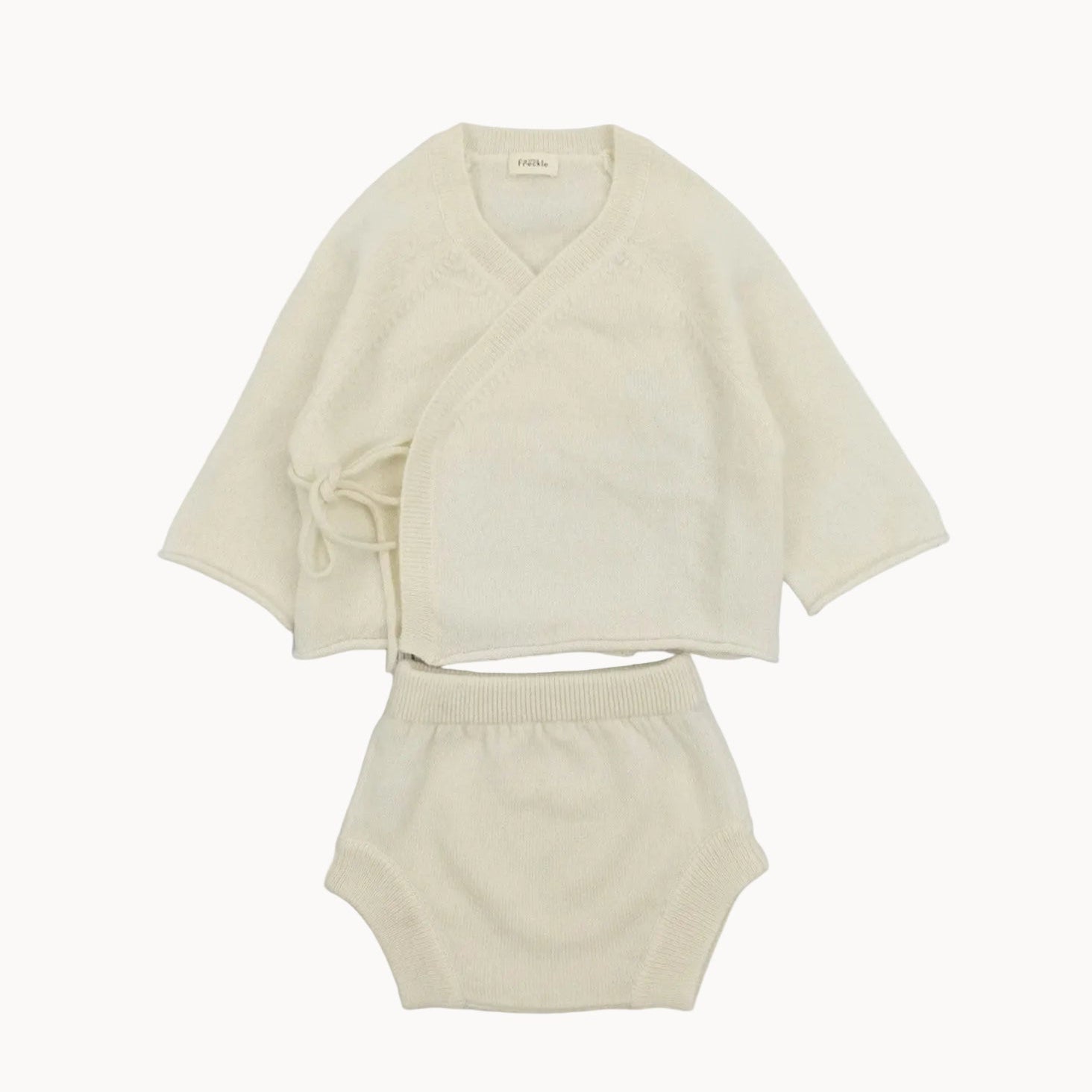 Beige cardigan and shorts set on a white background