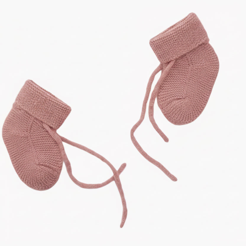 A pair of pink organic cashmere booties for babies, displayed on a white background.